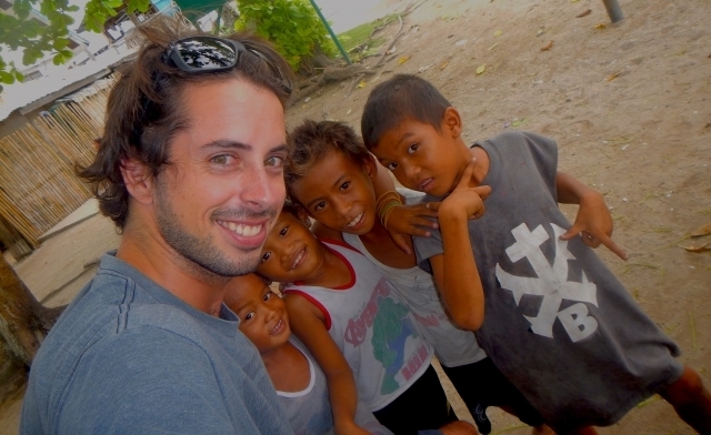 Rodrigo standing with children from a community in the Philippines